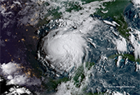 Image of hurricane as seen by satellite. Clouds formed into circular structure above Gulf of Mexico.